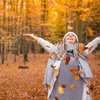 Happy Woman in Autumn leaves