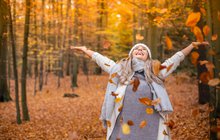 Happy Woman in Autumn leaves