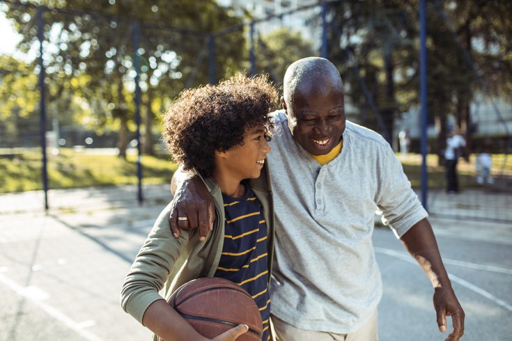 Purchased - Grandfather playing basketball with his grandson