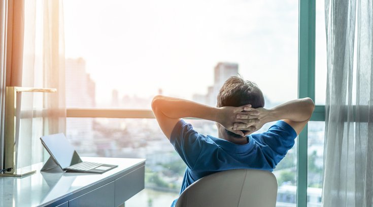 Man at desk staring out the window