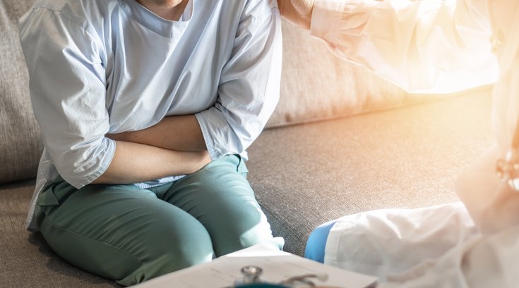 Abdominal pain patient woman having medical exam with doctor