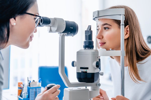 Purchased -  A doctor giving a patient an eye exam