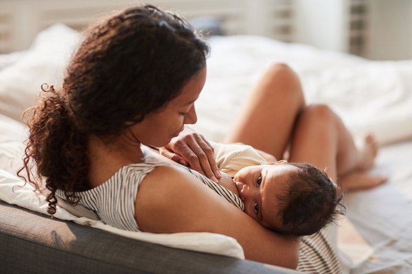 Purchased - A woman breastfeeding her child