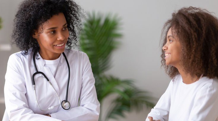 Purchased - Doctor speaking with her young patient