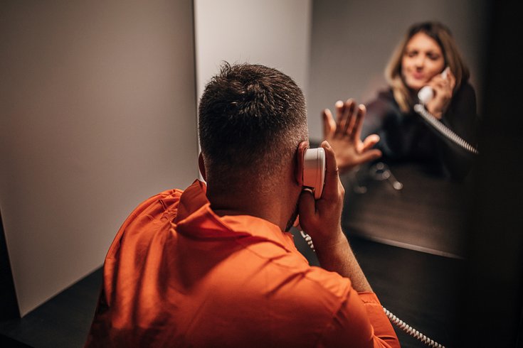Purchased - An incarcerated person talking to a loved one on the phone