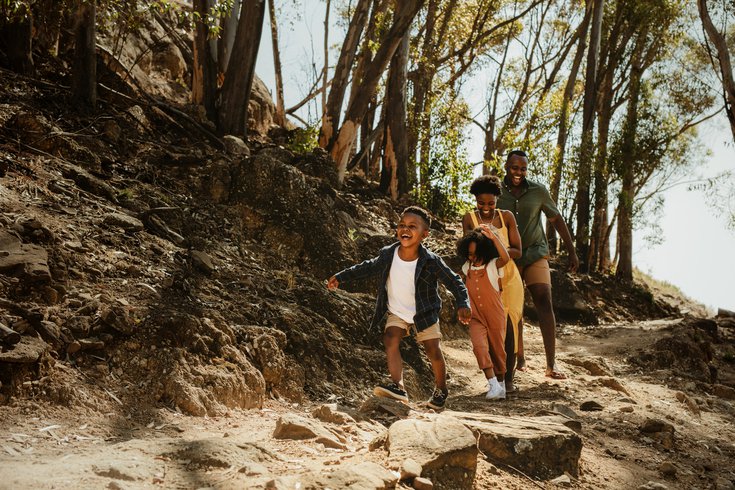 Purchased - Family running down rocky trail