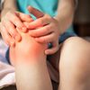 Purchased - Pain in the knee joints of the child. the boy's knees hurt stock photo