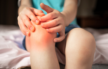 Purchased - Pain in the knee joints of the child. the boy's knees hurt stock photo