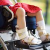 Disabled child sitting in wheelchair.