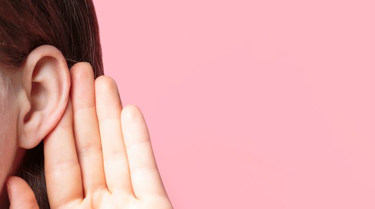 Purchased - girl listens attentively with her palm to her ear