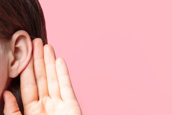 Purchased - girl listens attentively with her palm to her ear