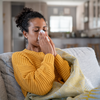 Limited - Sick woman blowing her nose not feeling well