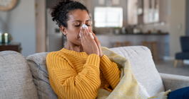 Limited - Sick woman blowing her nose not feeling well