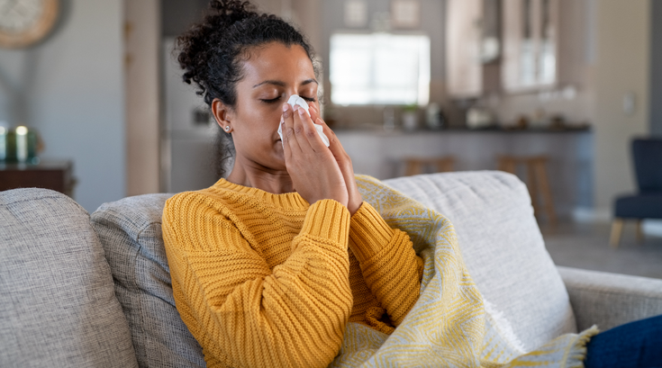 Limited - Sick woman blowing her nose not feeling well