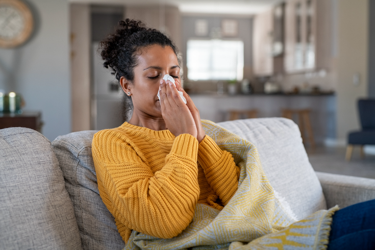 Limited - Sick woman blowing her nose not feeling well