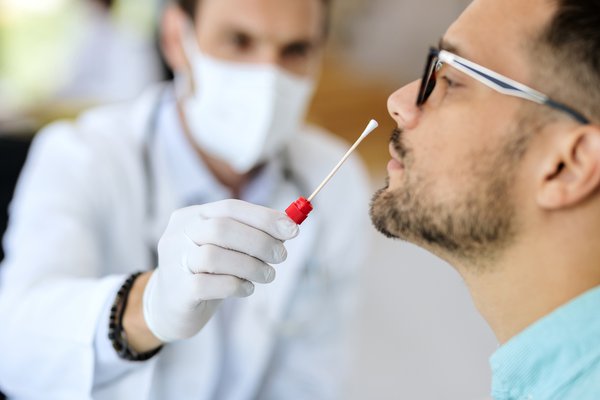 Purchased - Close-up of a man having PCR test at medical clinic