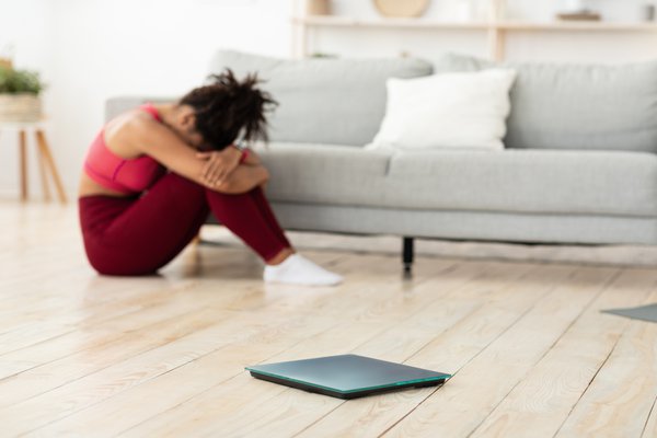 Purchased - Woman Crying Sitting Near Weight-Scales