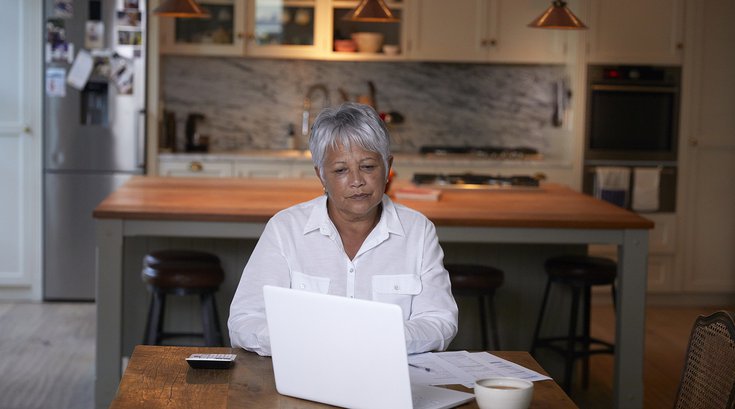 Limited - Senior citizen sitting on the computer
