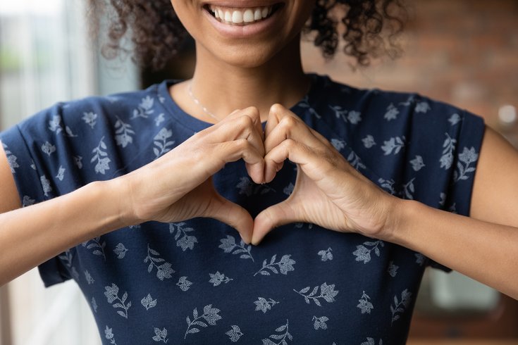 Purchased - Woman making heart with hands smiling