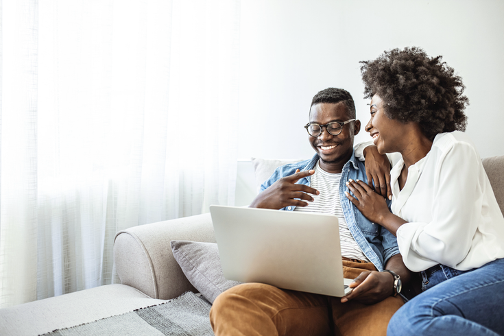 Purchased - Couple reviewing health plans on the sofa