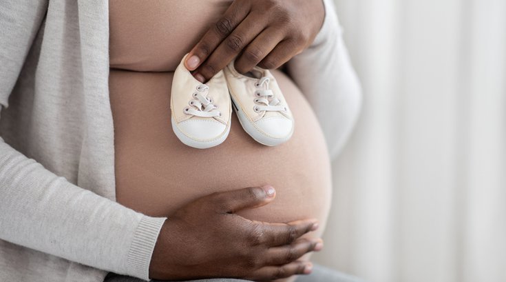 Purchased - Woman Embracing Belly And Holding Small Baby Shoes