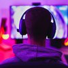 Purchased - young man wearing headset and play computer video games online