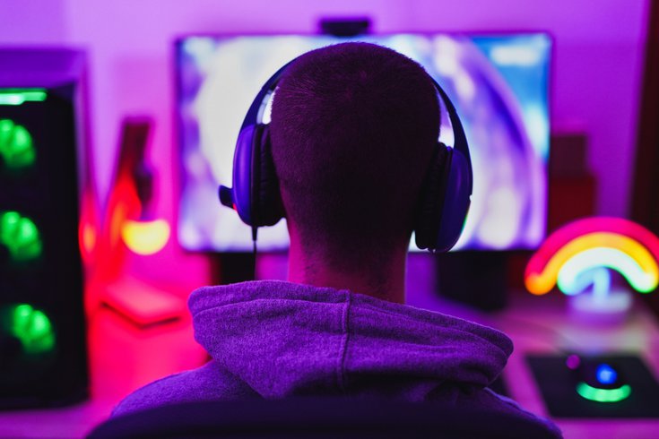 Purchased - young man wearing headset and play computer video games online