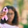 Purchased - Woman holding pink breast cancer ribbon