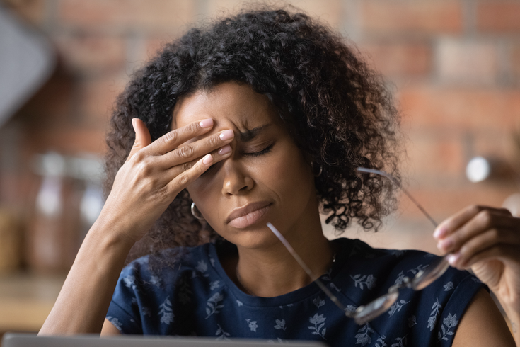 Purchased - Woman working with a headache