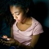 Purchased - teen girl using smartphone at night