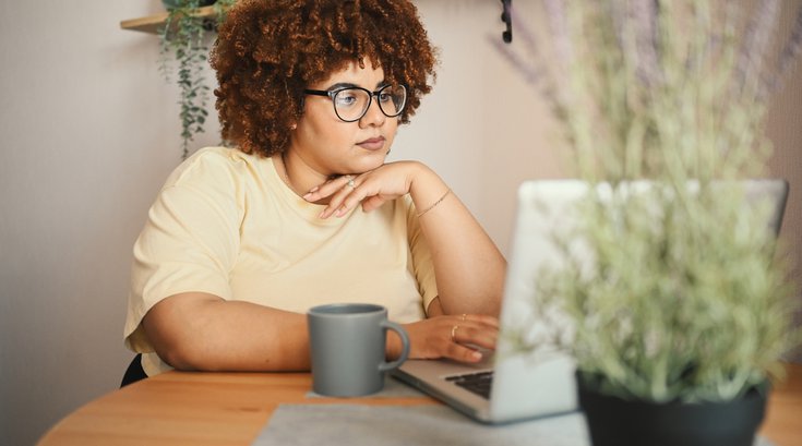 Purchased - woman working on laptop computer at home office workspace