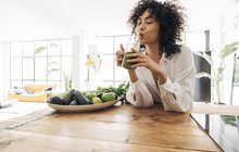 Purchased - woman drinking green juice with reusable bamboo straw