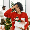 Purchased - woman standing by christmas tree with decoration tired