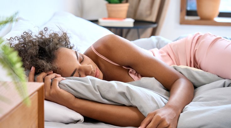 Purchased - woman sleeping in comfortable bedroom with eyes closed.
