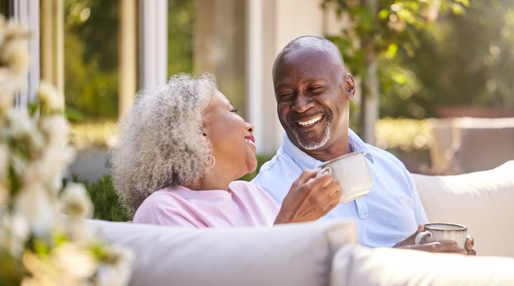 Purchased - Senior couple sitting on a bench enjoying coffee