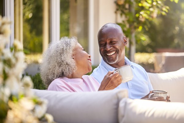 Purchased - Senior couple sitting on a bench enjoying coffee