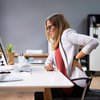 Purchased - Woman sitting at her desk with back pain