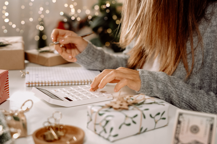 Purchased - Woman checking her holiday expenses