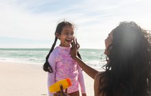 Purchased - Parent putting sunscreen on child