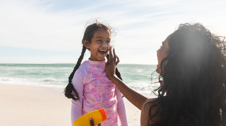 Purchased - Parent putting sunscreen on child