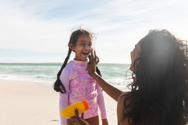 Purchased - Parent putting sunscreen on child