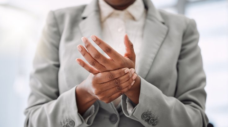 Purchased - Closeup shot of an unrecognisable businesswoman experiencing hand pain