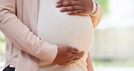 Purchased - A pregnant person holding their tummy