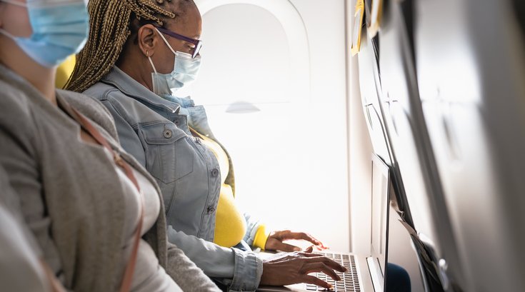 Purchased - Woman working on a plane with a mask on