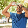 Purchased - a man pouring water on his head due to heat