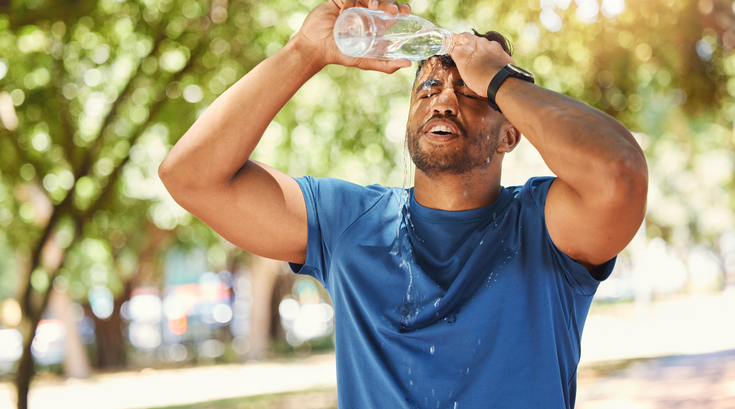 Purchased - a man pouring water on his head due to heat