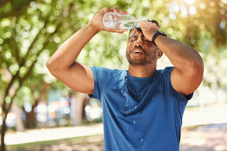Purchased - a man pouring water on his head due to heat