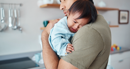 Purchased - Father holding a baby