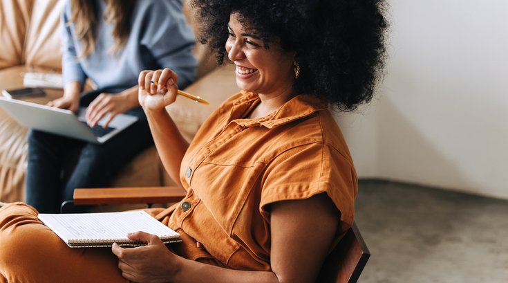 Purchased - Woman smiling in a business meeting