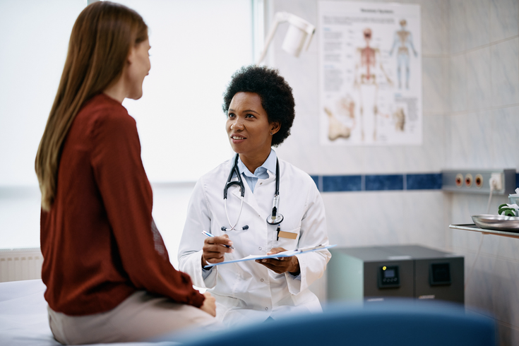 Purchased - Doctor speaking with her patient in the office